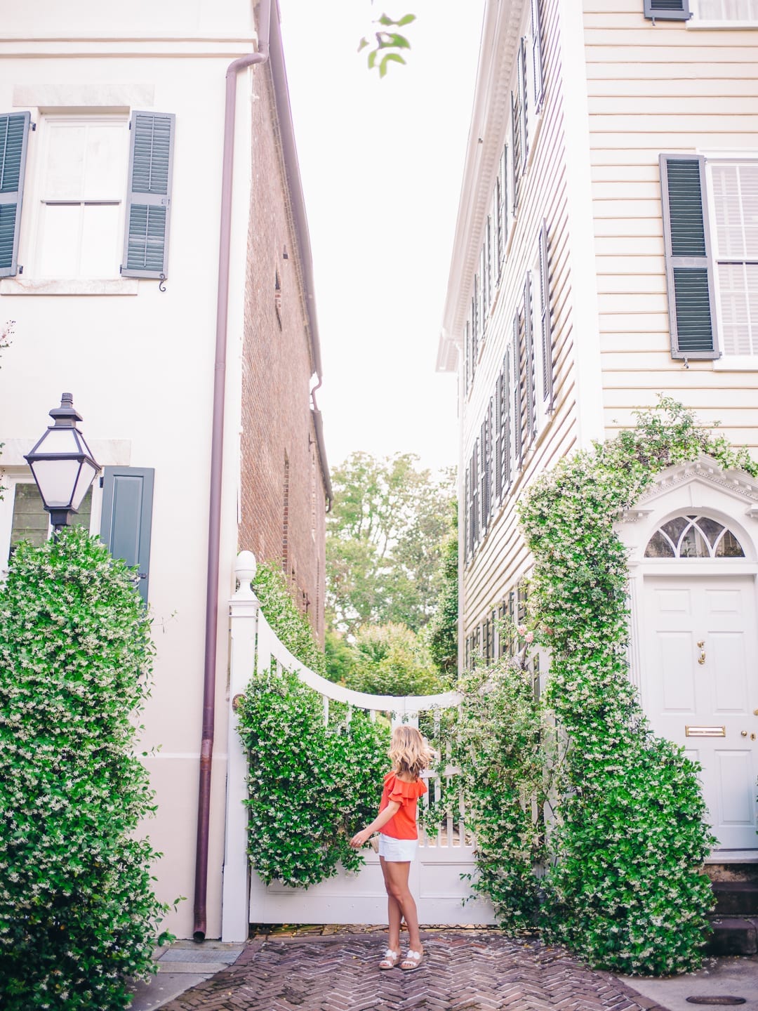 girl in red top in front of jasmine