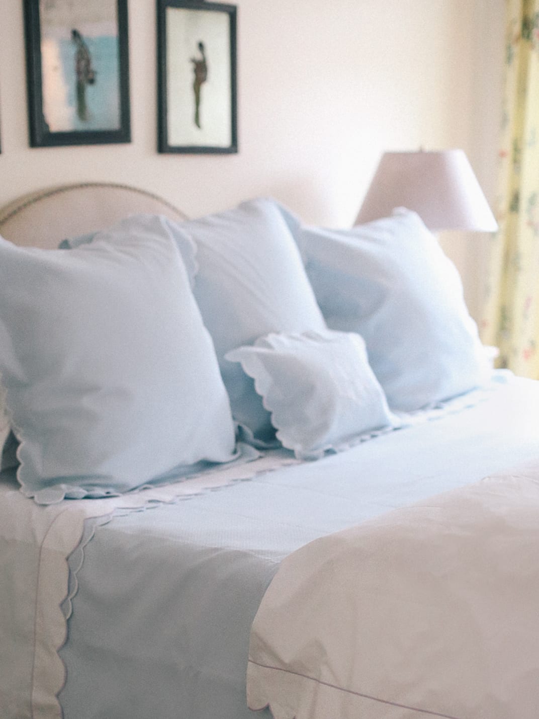 Dreamy Bedding with Matouk - Pastel blue pillows and linens with scalloped edges on a bed